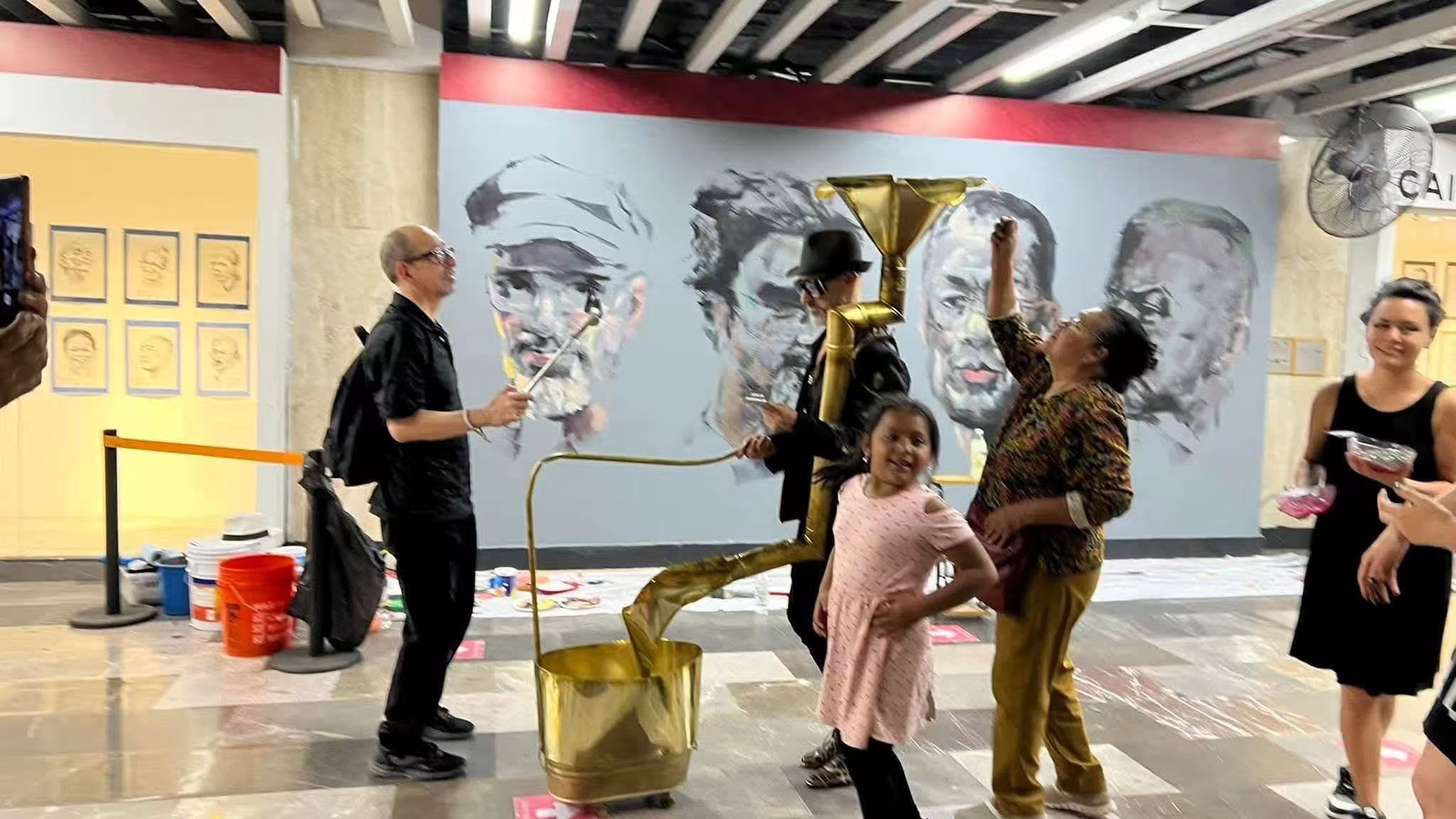 Performance with golden installation at Mexico City Metro mural site